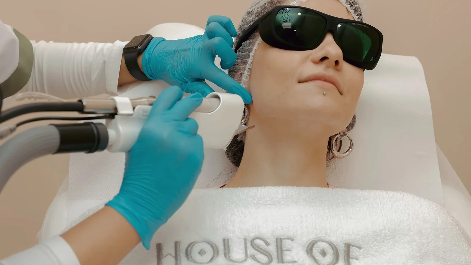 A professional laser skin treatment performed with protective eyewear in place.