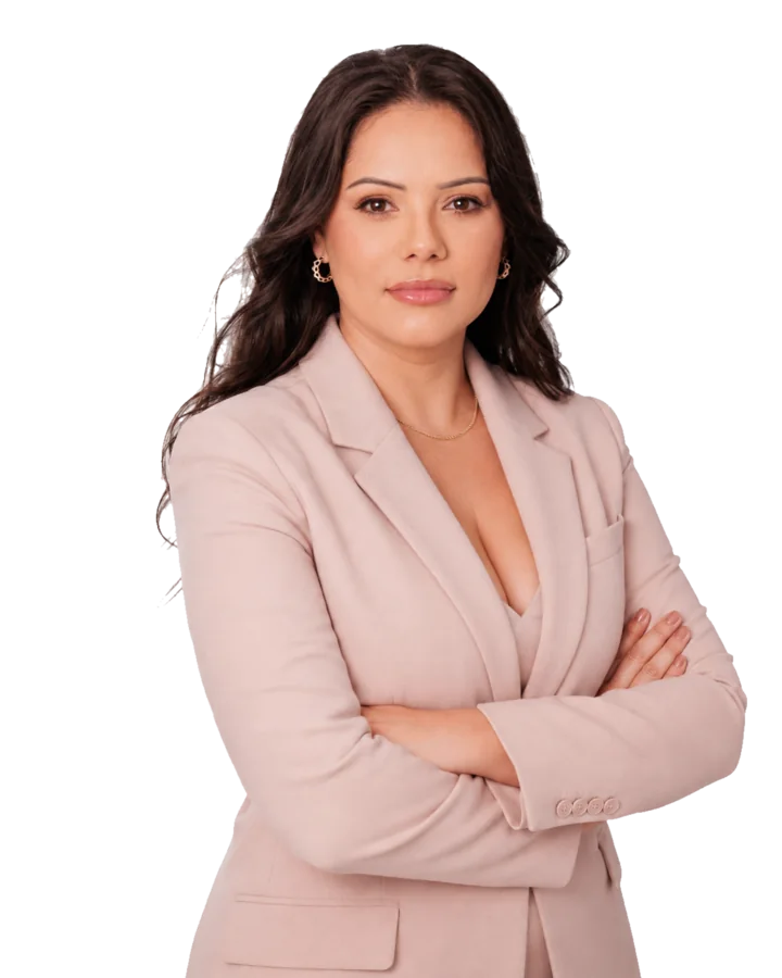Franciele Sofiati wearing a muted blush suit with her arms folded.