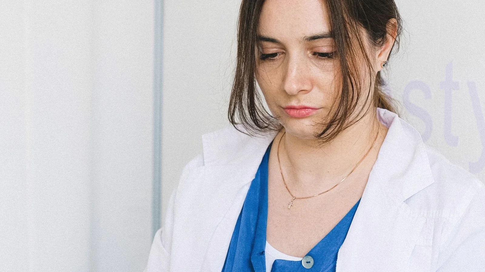 A clinician concentrating during a professional skin-care appointment.