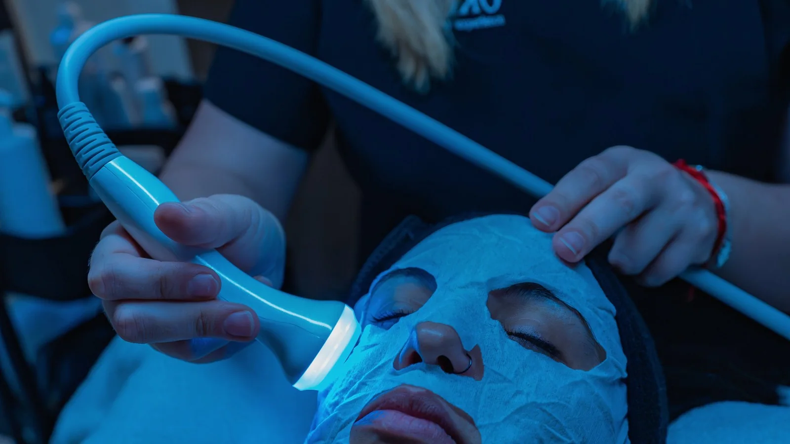 An energy-based facial treatment being performed in a professional setting.